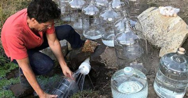 Mukhande Singh Holding Water Jugs