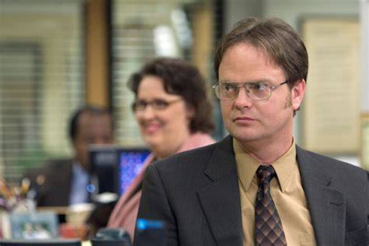 Why does Dwight Invite Oscar to the funeral?